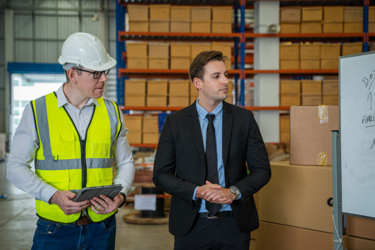 Warehouse manager meeting with his team in a large distribution